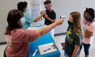 Image of masked students being given temperature checks in Wylie, Texas