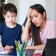 Image of a parent and child frustrated by distance online learning