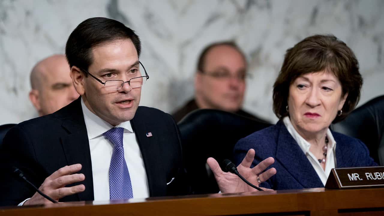 Photo of Sen. Marco Rubio, R-Fla., left, accompanied by Sen. Susan Collins, R-Maine, right