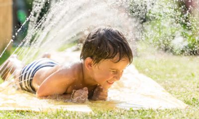 Photo of a child cooling off with a sprinkler