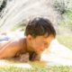 Photo of a child cooling off with a sprinkler